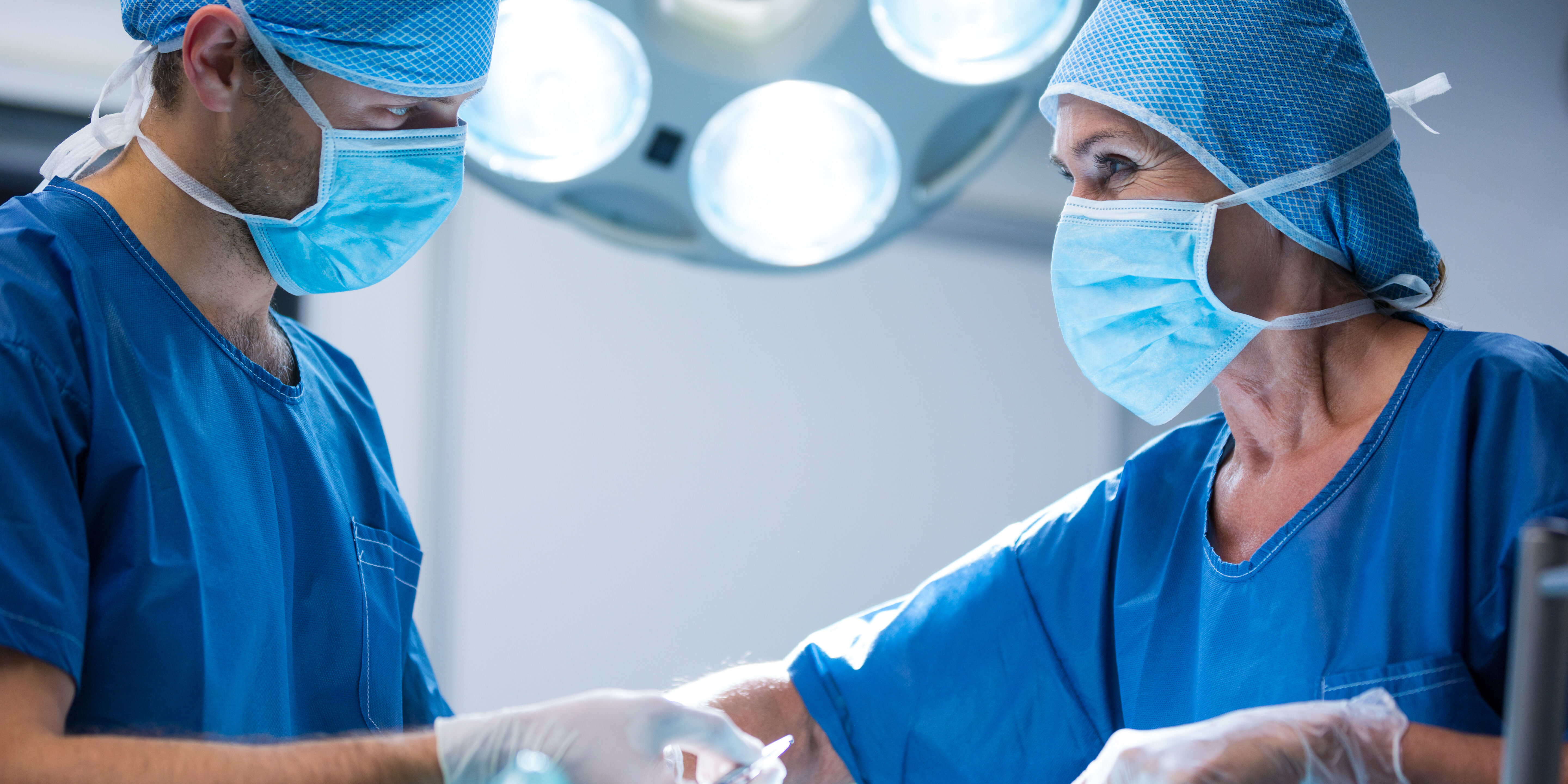 Surgeons performing operation in operation room